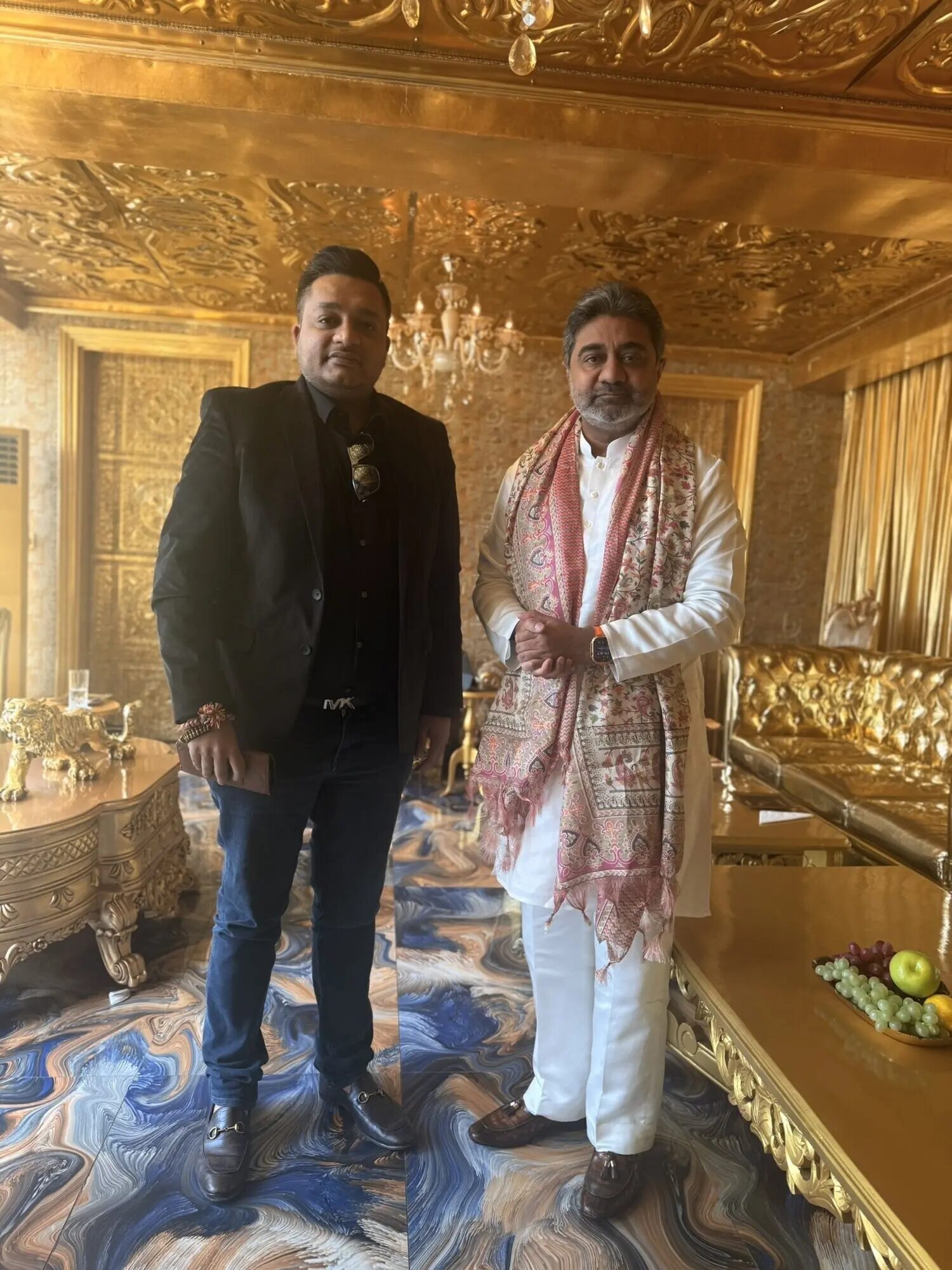 Nitish Jindal and Abhishek Verma standing side by side in an ornate gold-toned room.