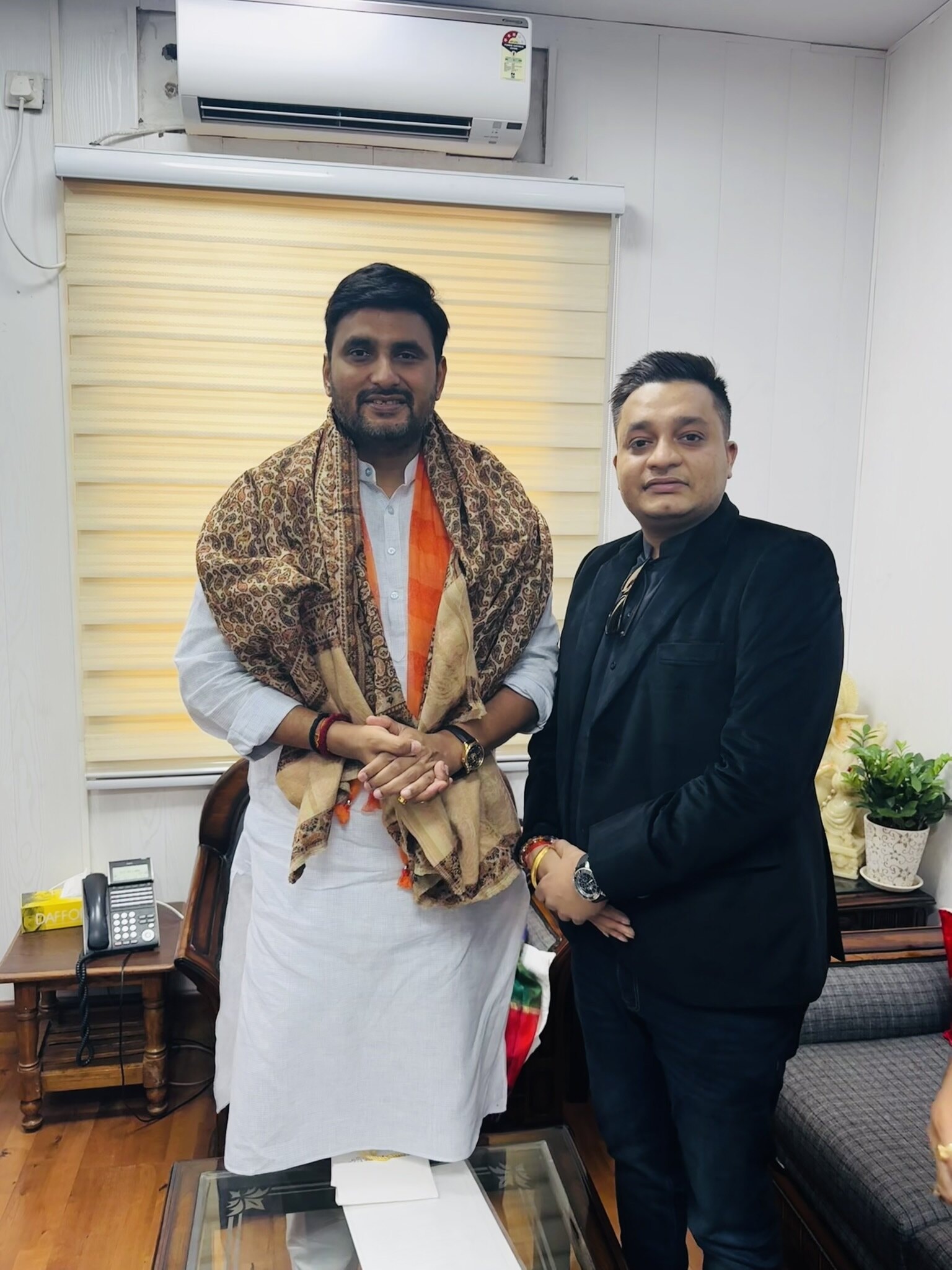 Nitish Jindal standing beside Neeraj Singh in a bright indoor room.
